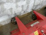 a red machine that is sitting on the ground