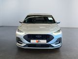 the front view of a silver car in a showroom