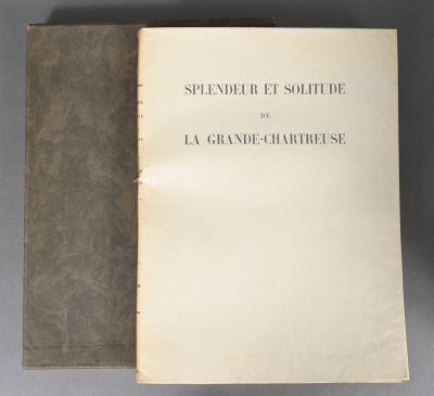an open book sitting on top of a table next to a pair of scissors