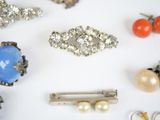 many different types of jewelry on a white surface