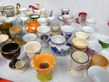 many cups and cups that are sitting on a table