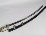 two swords with gold and black handles sitting on a white surface