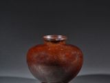 two brown vases sitting next to each other on a gray surface