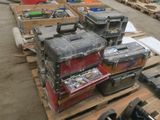 many boxes of tools sitting on pallets in a warehouse