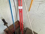 a picture of a red and blue hand pump in a garage