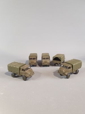 six toy army vehicles that are lined up on a table