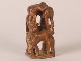 an image of a wooden sculpture of a man and a dog