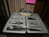 a tray with spoons, forks, and spoons on it