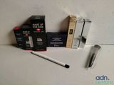 a box of makeup and a pen on a table