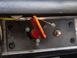 a close up of a car door handle with a red button