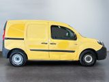 the yellow van is parked on the concrete floor in the room
