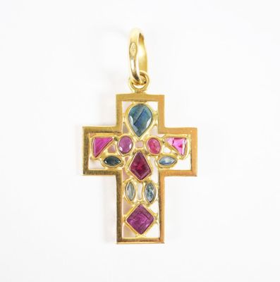 an image of a gold cross with multi colored stones on it
