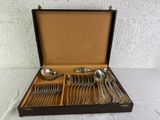 a wooden box with silverware in it on a table