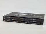 three books are stacked on top of each other on a white surface