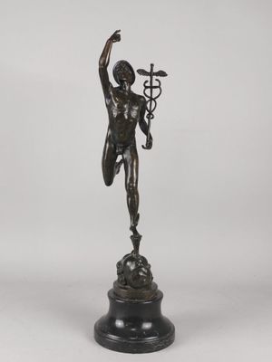 a bronze statue of a man holding a cross on a pedestal