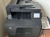 a printer sitting on top of a desk next to a phone
