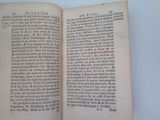 an open book on a table with a white background
