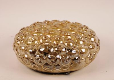 a gold colored glass bowl with small bubbles on it
