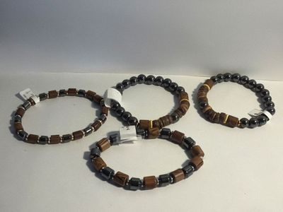 three bracelets with brown and black beads on a white surface