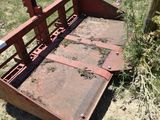 a rusted metal bed sitting in the middle of a field