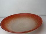 a red and white plate sitting on a white surface