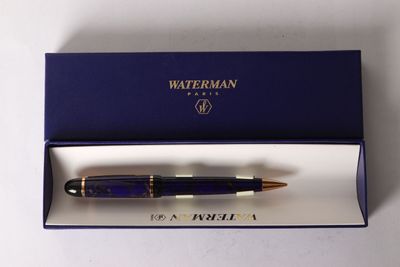 the pen is in a blue box on a white surface