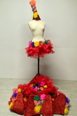 a mannequin with a red dress and a hat on top of it