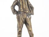 bronze statue of a man with a hat and a jacket