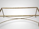 an image of a bamboo and metal coffee table with a glass top
