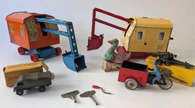 four different types of toy vehicles and tools on a white surface
