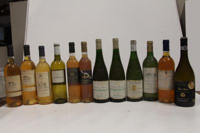 many bottles of wine lined up on the counter
