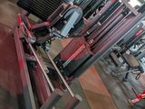 a gym with a lot of machines in the room