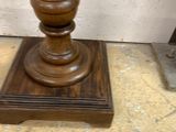 a wooden table with a vase on top of it