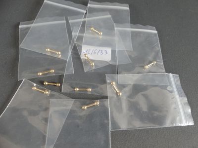 a lot of bags with screws on them on a table