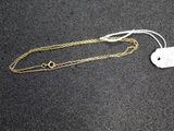 a close up of a necklace with a tag attached to it
