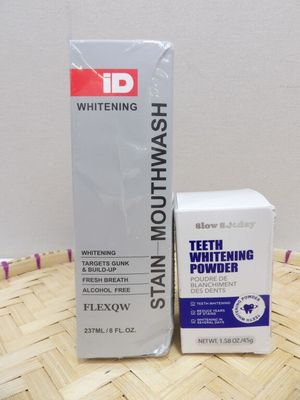 whitening toothpaste and a box of toothpaste sitting on a bamboo mat