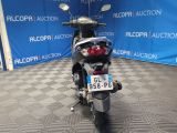 a motorcycle that is parked in front of a blue wall