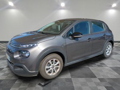 the grey citrole is parked on a checkered tile floor