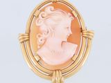 une broche-camée en or et corail représentant le profil d'une femme