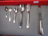a lot of silver spoons and forks on the table