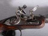 an old gun with a man riding a horse on it