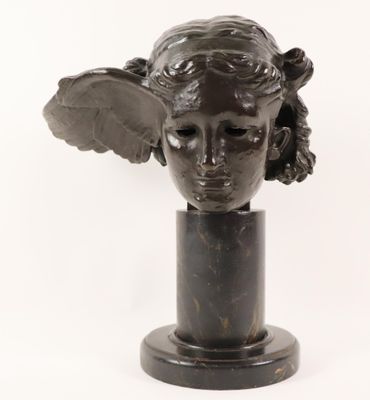 sculpture of a woman ' s head with wings on a marble base