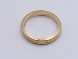 a close up of a gold ring on a white surface