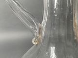 a clear glass pitcher that is sitting on a table