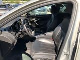 the interior of a car with the door open and the driver ' s seat down