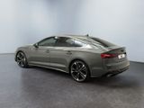 the rear end of a grey audi s5 sedan in a showroom