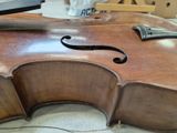 a close up of a violin that is being worked on