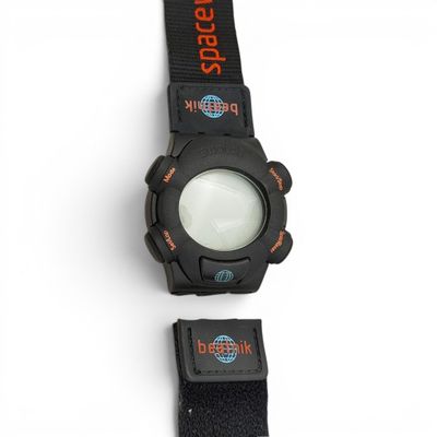 a close up of a watch on a white surface with a black strap