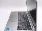 a silver laptop with a blue sticker on the screen