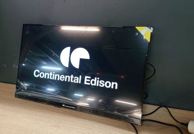 a flat screen television sitting on a desk with a mouse